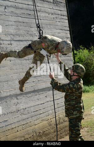 Greek paratroopers with 1st Paratrooper Commando Brigade, Greek Army conduct rappelling training for Sky Soldiers from B Company, 1st Battalion, 503rd Infantry Regiment, 173rd Airborne Brigade, May 20, 2017 in Camp Rentina, Greece as a part of Exercise Bayonet Minotaur 2017. Bayonet-Minotaur is a bilateral training exercise between U.S. Soldiers assigned to 173rd Airborne Brigade and the Greek Armed Forces, focused on enhancing NATO operational standards and developing individual technical skills. Stock Photo