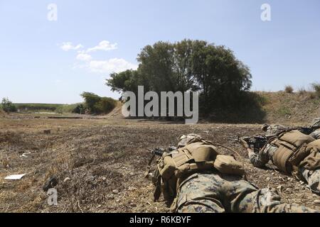 US Navy Personnel take aim at their targets during a live-fire 9mm ...
