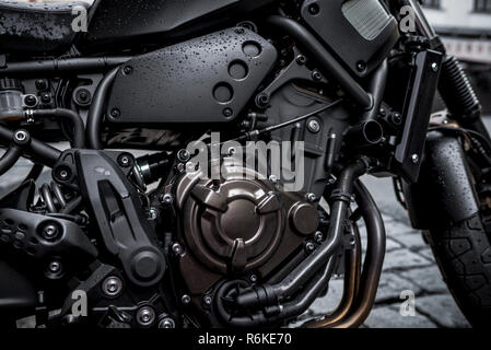 Right side of modern high power motorbike with detailed view of engine and parts; dark abstract background Stock Photo