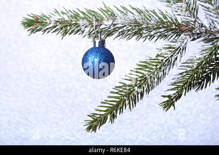 Christmas tree and New Year's colorful balls with ribbon on blurred background. Decoration for happy holidays. Copy space. Stock Photo