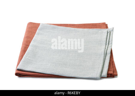 Folded brown and gray textile napkins stacked on white background Stock Photo