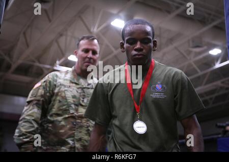 A Paratrooper with the 82nd Airborne Division walks off a fighting area after winning his weight class in the Army Combatives portion of the All American Week 100 Combatives/Boxing tournament at Fort Bragg, N.C., May 24, 2017.    During All American Week 100, Paratroopers from throughout the Division competed in softball, soccer, flag football, tug-of-war, combatives, boxing, a best squad competition and a combat fitness test for bragging rights and a shot at “Best Battalion.” All American Week is an opportunity for Paratroopers, past and present, to come together and celebrate the history, he Stock Photo