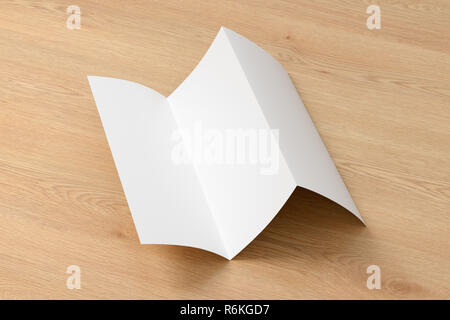 Blank trifold brochure A4 unfolded booklet on wooden background with clipping path. 3D illustration Stock Photo