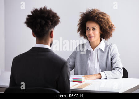 Businesswoman Interviewing Male Applicant Stock Photo
