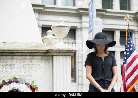 Cast member Lexi Lawson (Eliza Hamilton) of the esteemed Broadway musical, Hamilton bows her head in a moment of silence with the Coast Guard Cutter Hamilton crew, to honor the shared namesake of their play and vessel, founder of the Coast Guard, Alexander Hamilton, at his gravesite at Trinity Church, in New York City, May 26, 2017. The wreath-laying ceremony was a part of Fleet Week New York and Memorial Day weekend activities. U.S. Coast Guard Stock Photo