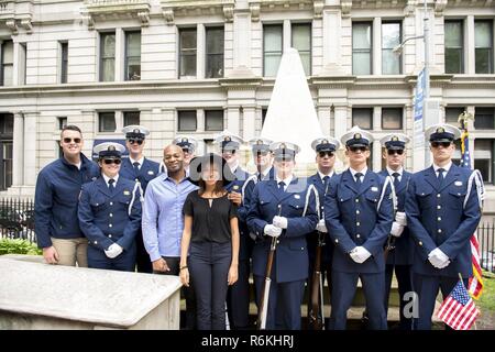 Cast members Brandon Victor Dixon (Aaron Burr) and Lexi Lawson (Eliza Hamilton) of the esteemed Broadway musical, Hamilton pose for a photo with the U.S. Coast Guard Silent Drill Team on the grounds of Trinity Church, in New York City, May 26, 2017. As a part of Fleet Week New York, crew members from the Coast Guard Cutter Hamilton and guests honored Coast Guard founder, Alexander Hamilton, with a memorial wreath-laying ceremony at his grave. U.S. Coast Guard Stock Photo
