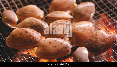 Fresh clams grilling on barbecue fire Stock Photo