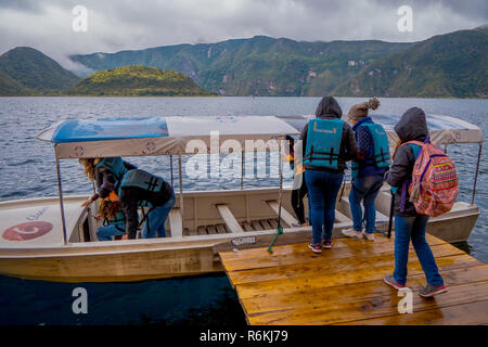 CUICOCHA, ECUADOR, NOVEMBER 06, 2018: Tourists boarding a boat to have a tour in the Cuicocha lake in Ecuador. Stock Photo