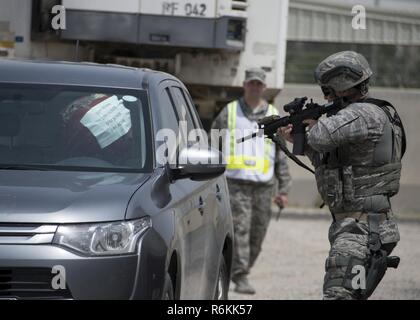 A 387th Expeditionary Security Forces Squadron member locates and identifies a simulated vehicle borne improvised explosive device as a wing inspection team member evaluates him during a force protection condition delta exercise at an undisclosed location in Southwest Asia, April 27, 2017. The 387th Air Expeditionary Group conducted a force protection condition delta exercise to demonstrate base defense capabilities in response to increased terrorist threat levels. Stock Photo