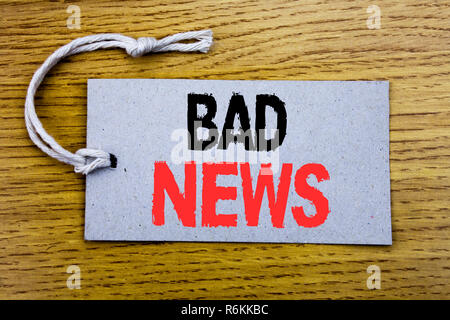 Conceptual hand writing text caption showing Bad News. Business concept for Failure Media Newspaper written on price tag paper with copy space on the wooden vintage background Stock Photo