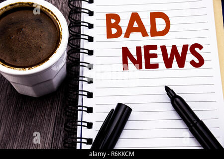 Writing text showing Bad News. Business concept for Failure Media Newspaper written on notebook book note paper on the wooden wood background. With coffee and black marker. Stock Photo