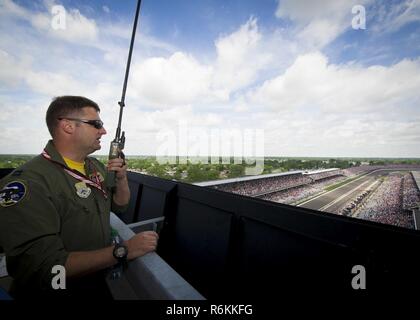 Capt. Micah McCracken, 69th Bomb Squadron B-52 instructor pilot, checks in with the aircrew via radio before they fly over the Indianapolis Motor Speedway, Indianapolis, Ind., May 28, 2017. The aircraft from Minot Air Force Base, N.D., passed over the speedway as the National Anthem played, kicking-off the Indianapolis 500 race. Stock Photo