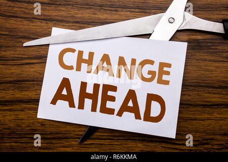 Hand writing text caption inspiration showing Change Ahead Red Word. Business concept for Future Changes Written on note, wooden back with colourful scissors meaning destroy stop of something. Stock Photo