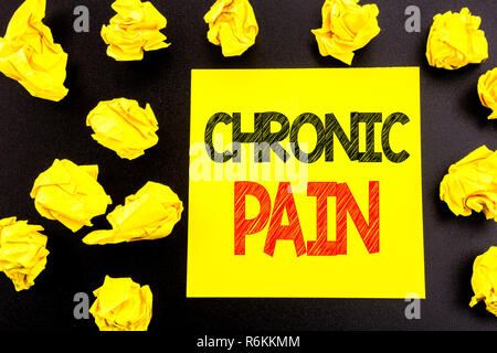 Conceptual hand writing text showing Chronic Pain. Business concept for Feeling Bad ill Care written on sticky note paper. Folded yellow papers on the background Stock Photo