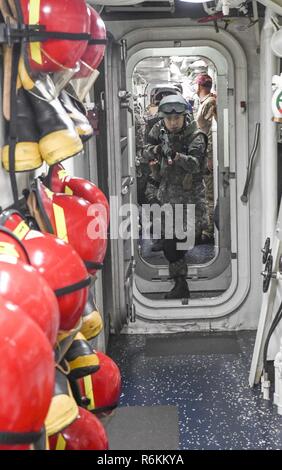 A U.S. Navy boarding team practices tactical movements aboard the USS ...
