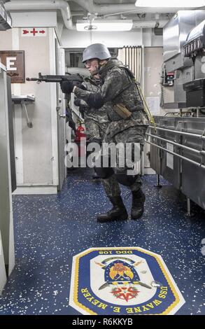 A U.S. Navy boarding team practices tactical movements aboard the USS ...
