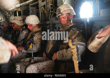 A Navy Corpsman with 3rd Marine Regiment fastens his safety harness in preparation for take-off following a long range raid simulation during Integrated Training Exercise (ITX) 3-17 at Marine Corps Air Station Yuma, Arizona, May 27. ITX is a combined-arms exercise enabling Marines across 3rd Marine Aircraft Wing to operate as an aviation combat element integrated with ground and logistics combat elements as a Marine air-ground task force. More than 650 Marines and 27 aircraft with 3rd MAW are supporting ITX 3-17. Stock Photo