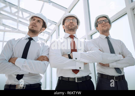 three architects standing in an empty office Stock Photo