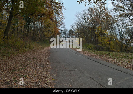 Empty mountain road at cloudy day during autumn time Stock Photo