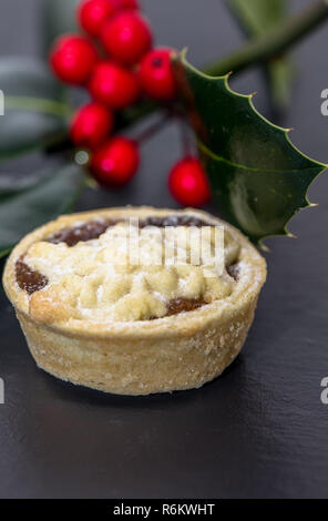 Mince pie and holly with red berries. Stock Photo