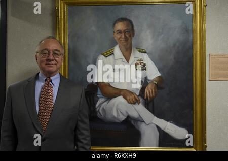 NEWPORT, R.I. (May 18, 2017) Retired Rear Adm. Jacob L. Shuford, U.S. Naval War College (NWC) president from Aug. 2004 until Nov. 2008, stands aside his official portrait in Conolly Hall at NWC. A group of former NWC presidents visited the school for an inaugural Past Presidents’ Colloquium and Strategy Review. The colloquium was initiated and developed by current NWC President Rear Adm. Jeffrey A. Harley, with the goal of drawing on the lessons and experiences of the former leaders to help steer the college’s current and future path. Stock Photo