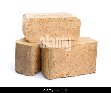 Biomass briquettes are a biofuel substitute to coal and charcoal. Isolated on white background. Stock Photo