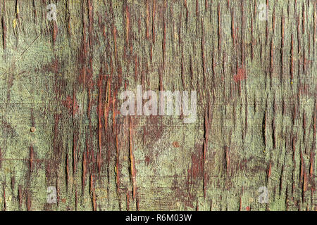 Old cracked painted wooden veneer background. Weathered natural plywood texture with paint and crack Stock Photo