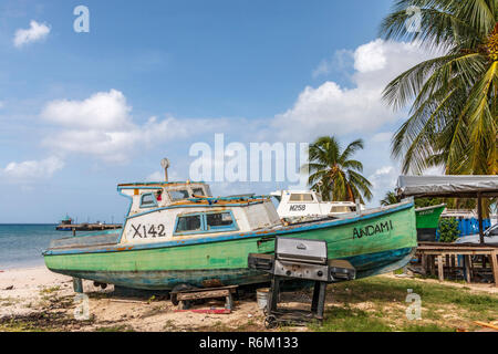 Fishing boats on the beach outside the famous fish market at Oistins where fresh caught fish is brought in for sale. Friday and Saturday night is the popular fish fry. Stock Photo