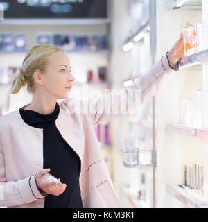 Beautiful woman shopping in beauty store. Stock Photo