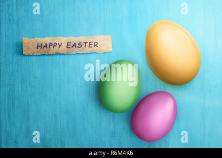 Happy Easter text in paper with colorful eggs Stock Photo