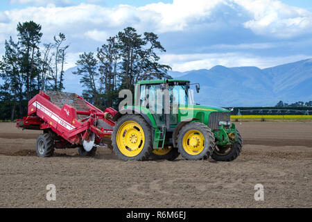 Shefffield, Canterbury, New Zealand - December 5 2018: A John Deere tractor and machinery on an agricultural farm preparing the soil for potato seedin Stock Photo