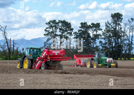 Shefffield, Canterbury, New Zealand - December 5 2018: John Deere tractors and machinery on an agricultural farm preparing the soil for potato seeding Stock Photo