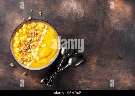 Top view of mango smoothie bowl with fruits Stock Photo