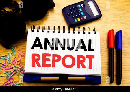 Conceptual hand writing text caption showing Annual Report. Business concept for Analyzing Performance  written on notebook book on the wooden background in Office with laptop coffee Stock Photo
