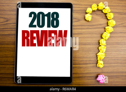 Word, writing 2018 Review. Business concept for Feedback On Progress Written on tablet, wooden background with question mark on the end. Stock Photo