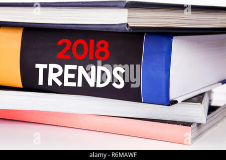 Hand writing text caption inspiration showing 2018 Trends. Business concept for Trending Data Prediction written on the book on the white background. Stock Photo