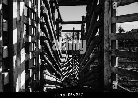 Black and white vacant cattle stables and pens on a ranch. Stock Photo