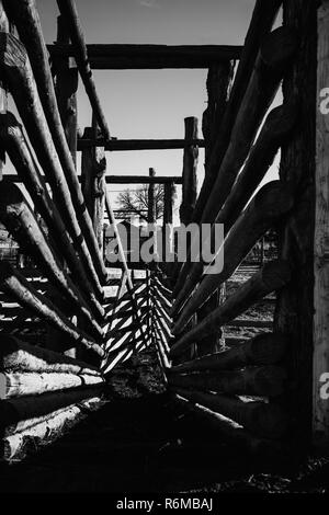 Black and white vacant cattle stables and pens on a ranch. Stock Photo