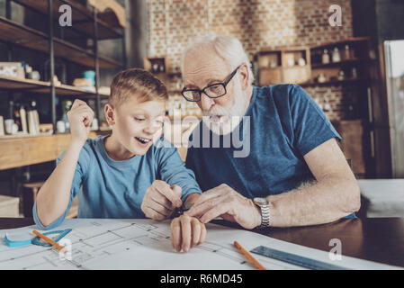 Surprised pensioner showing watches to his relative Stock Photo