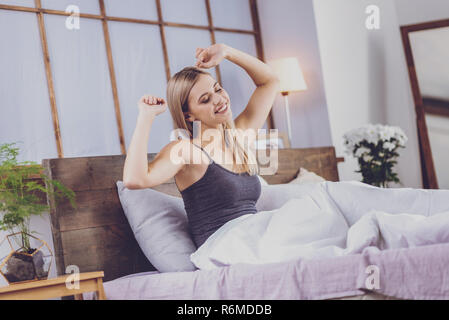 Charming young woman waking up in the morning Stock Photo