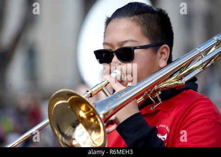 Prescott, Arizona, USA - December 1, 2018: Student from Mile High Middle School Band playing the trombone while marching in the Christmas parade Stock Photo