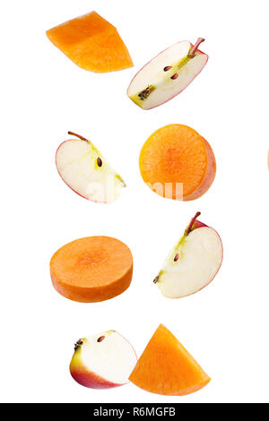 Falling apple and carrot isolated on white Stock Photo