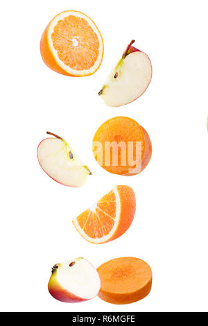 Falling apple, orange and carrot isolated on white Stock Photo
