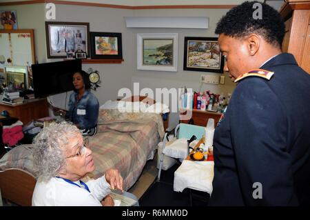 Maj. Angela Reed-Johnson, strategic operations chief for the Directorate of Human Resources for the U.S. Army Reserve’s 99th Regional Support Command at Joint Base McGuire-Dix-Lakehurst, New Jersey, visits May 26 with Edith Cobb at the Veterans Memorial Home in Vineland, New Jersey.  Cobb was at the 99th RSC’s dining out on May 12, an event to which dozens of residents from the home were invited. Stock Photo