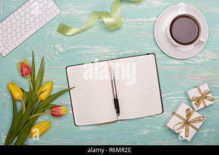 Keyboard, daily log, gifts and flowers. Stock Photo