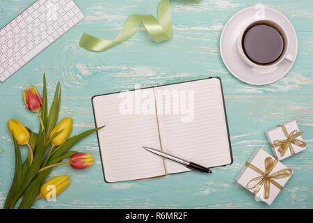 Keyboard, daily log, gifts and flowers. Stock Photo