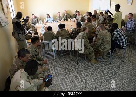 Airmen deployed to the 724th Expeditionary Air Base Squadron meet with members of the Forces Armées Nigeriennes at Nigerien Air Base 201, May 10, 2017. The two military groups meet on a regular basis to learn about their partner’s respective culture and build a lasting partnership. Stock Photo