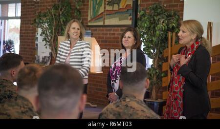 Gail Walters, wife of Gen. Glenn Walters, the Assistant Commandant of the Marine Corps, right, Suzanne Dana, wife of Lt. Gen. Michael Dana, the deputy commandant for Installations and Logistics, center, and Melissa VanOostrom, wife of Sgt. Maj. Robert VanOostrom, the sergeant major of Manpower and Reserve Affairs, talk to married Marines in Værnes Garnison, Norway, May 29, 2017. The ladies discussed the challenges Marine families face during deployments and offered insight to multiple programs offered to provide support. Stock Photo
