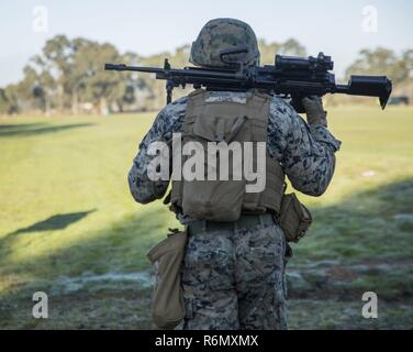 U.S. Marine Corps Cpl. Zach Love carries in the M249 to finish off the running portion of the section match May 22, 2017 at the Australian Army Skills at Arms Meeting in Puckapunyal, Australia. The competition brought together 20 teams from countries around to participate and learn from one another. AASAM incorporated various combat shooting drills to test the skills of each country. Love, a native of Leawood, Kansas, is a machine gunner with 3rd Battalion, 4th Marine Regiment. The battalion is currently deployed to Australia in support of Marine Rotational Force Darwin. Stock Photo