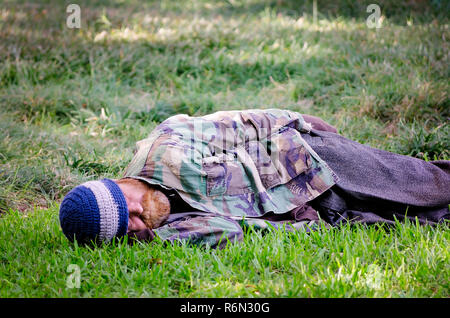 A homeless man sleeps in Jackson Square, Nov. 15, 2015, in New Orleans, Louisiana. (Photo by Carmen K. Sisson/Cloudybright) Stock Photo